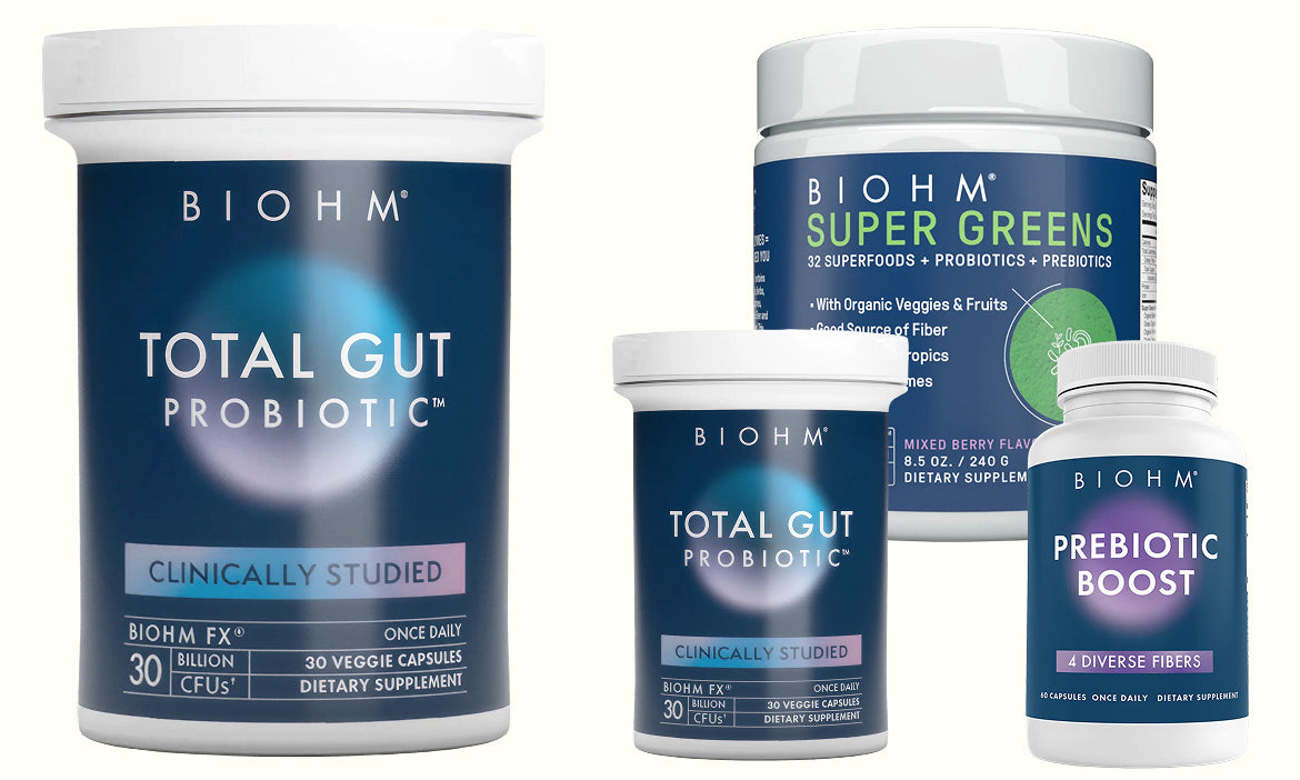 Biohm supplement containers including Total Gut Probiotic and Super Greens on a white background