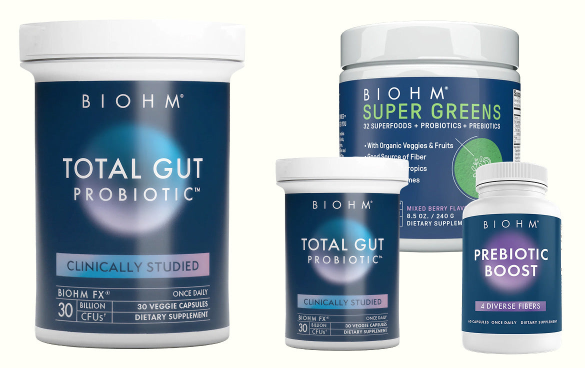 Biohm supplement containers including Total Gut Probiotic and Super Greens on a white background