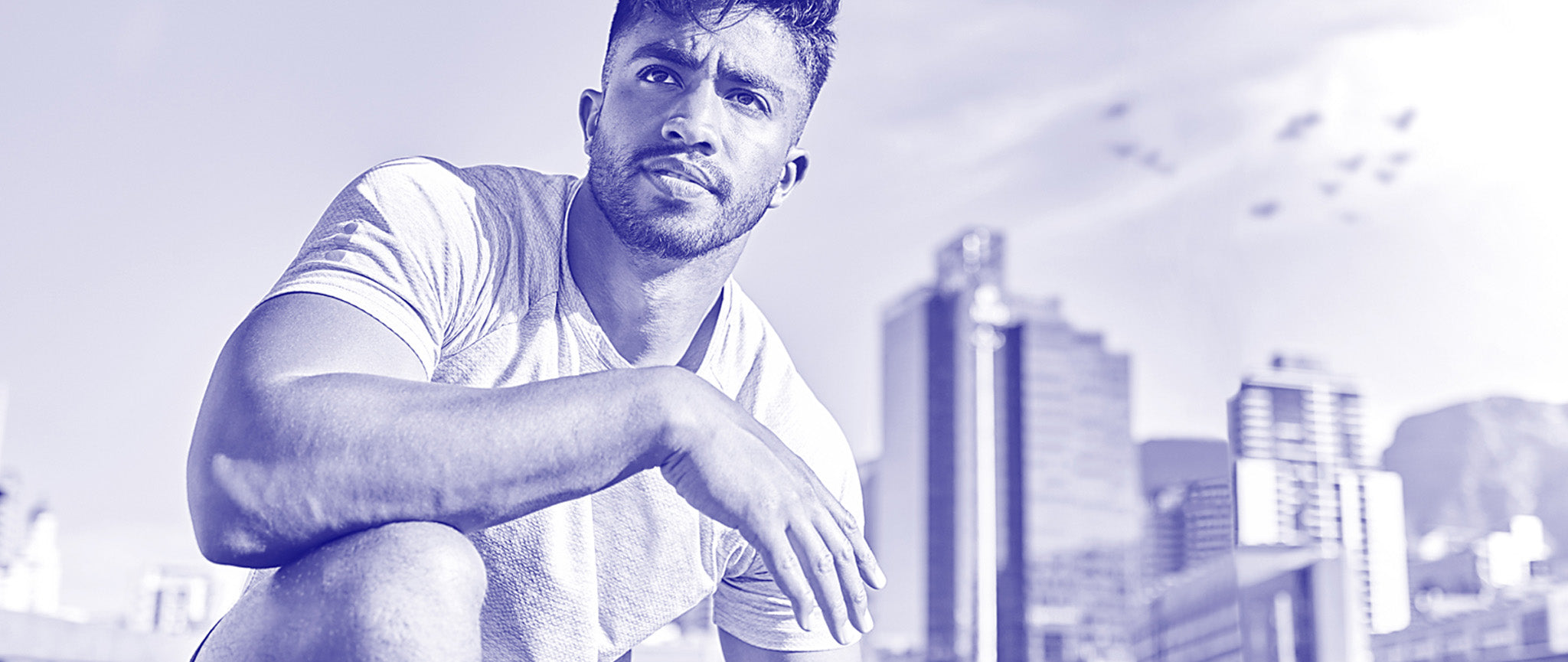 Man sitting with a cityscape in the background