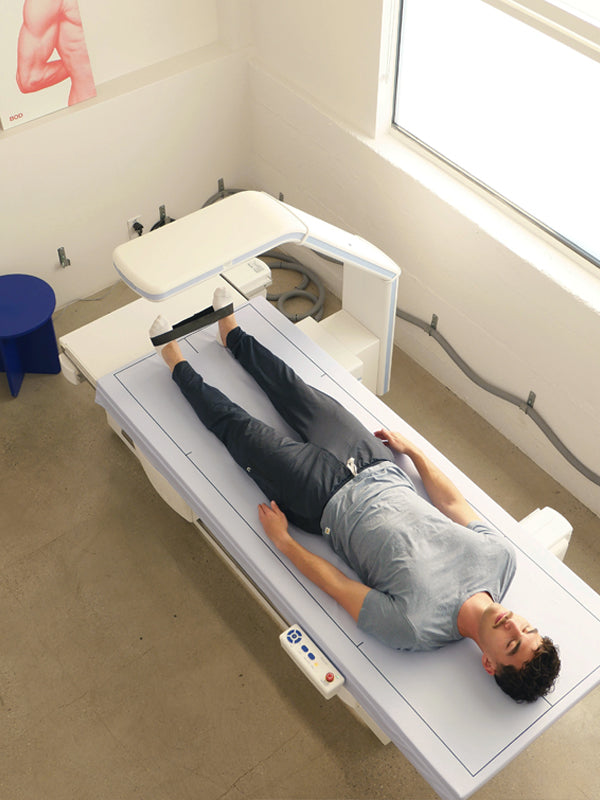 BOD customer lying on a DEXA scan imaging machine at the BOD store in Venice, CA.
