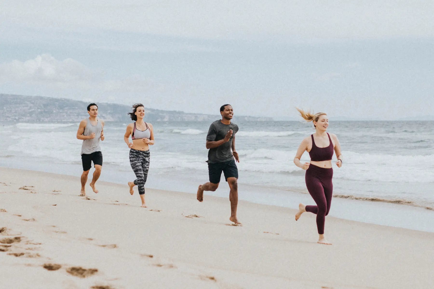 Bone mass density test relevance for active individuals running together barefoot along the shoreline.