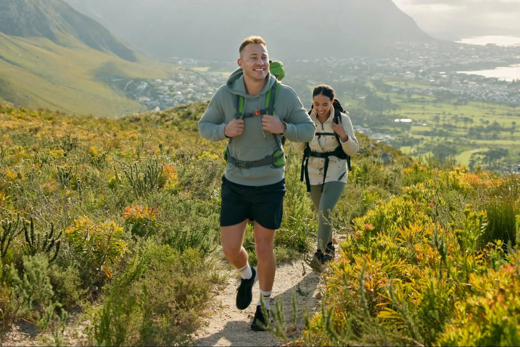 DEXA body scan benefits for active hikers trekking up a mountain trail with backpacks and scenic views.