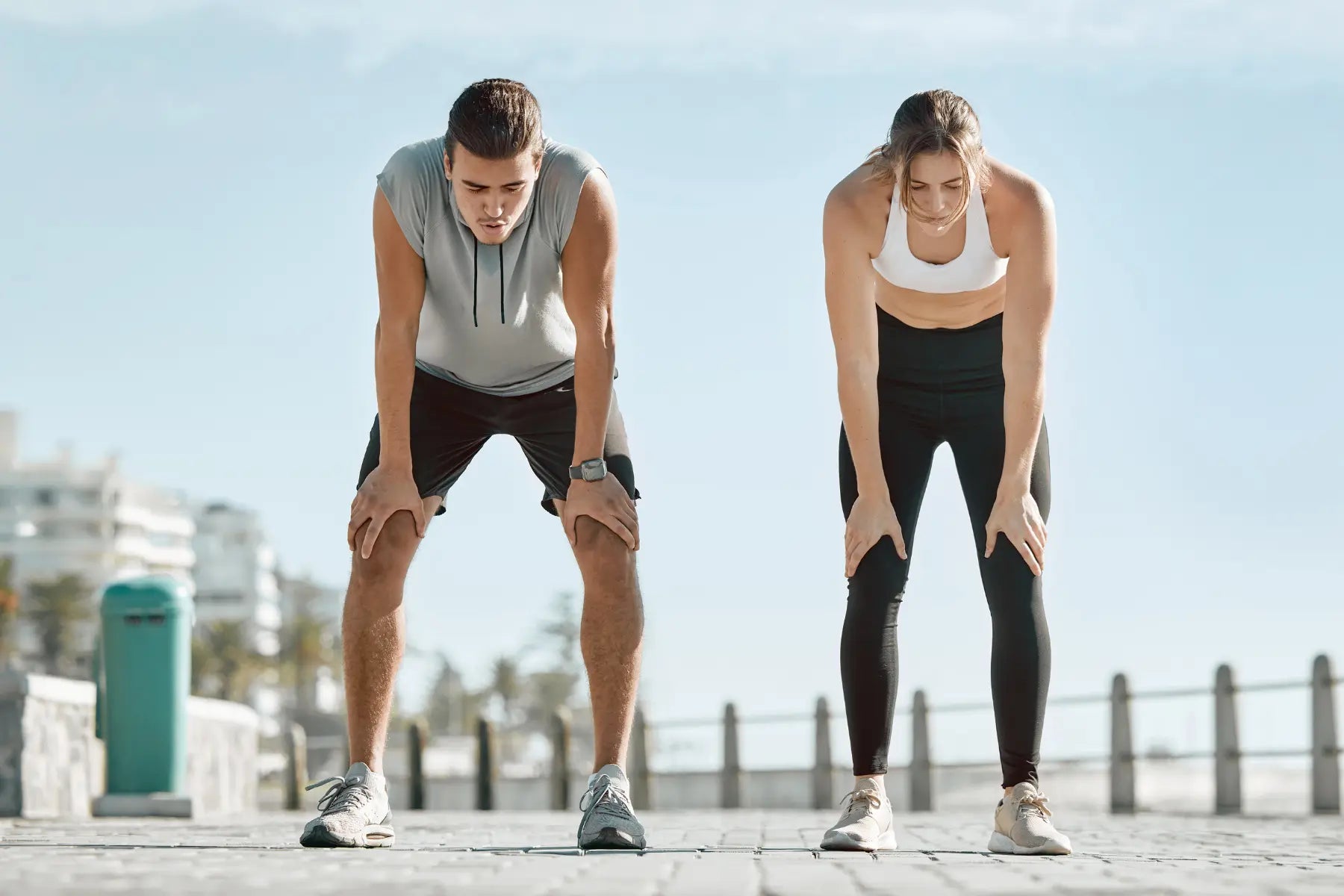 DEXA scan eligibility shown by two fit individuals resting after outdoor exercise, indicating health-conscious lifestyle and fitness level.