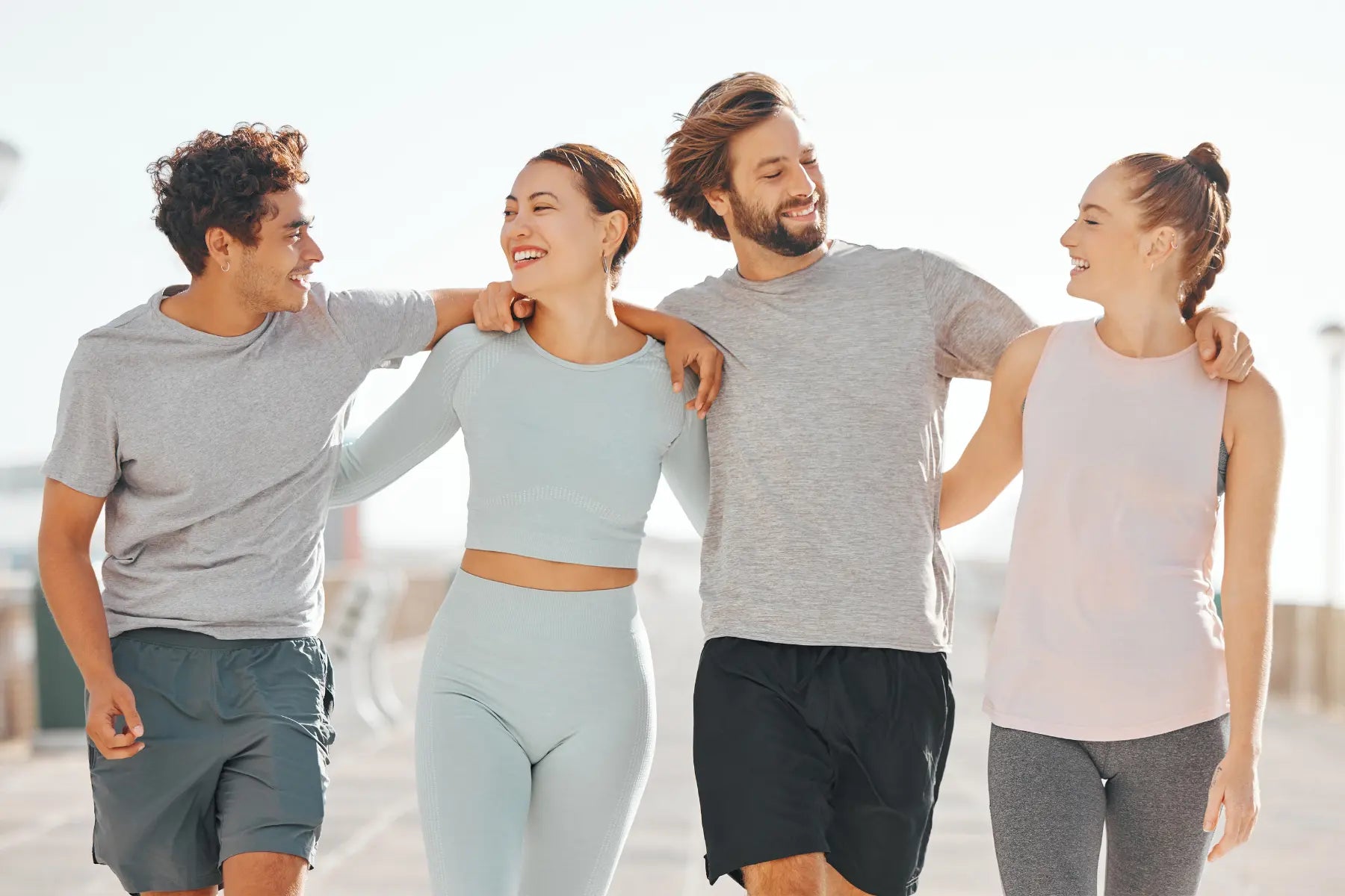 DEXA test for body fat shown by a group of active friends walking outdoors promoting fitness and healthy body composition