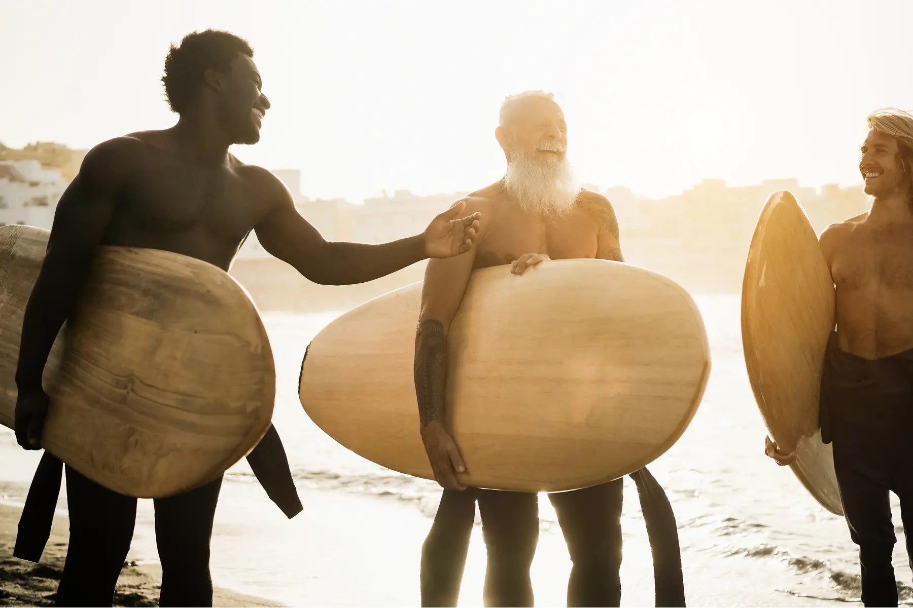 Measure body fat levels in active surfers laughing and holding boards after a session on the beach.