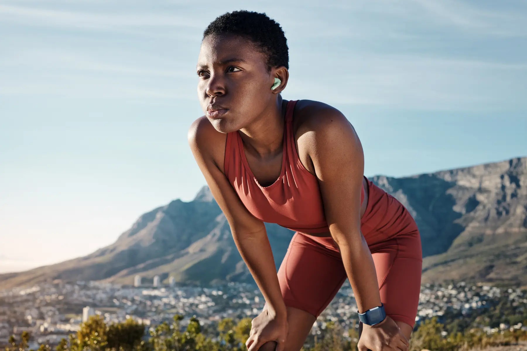 PHY scan results reflected in athlete recovering post-run with scenic mountain backdrop and fitness tracker.
