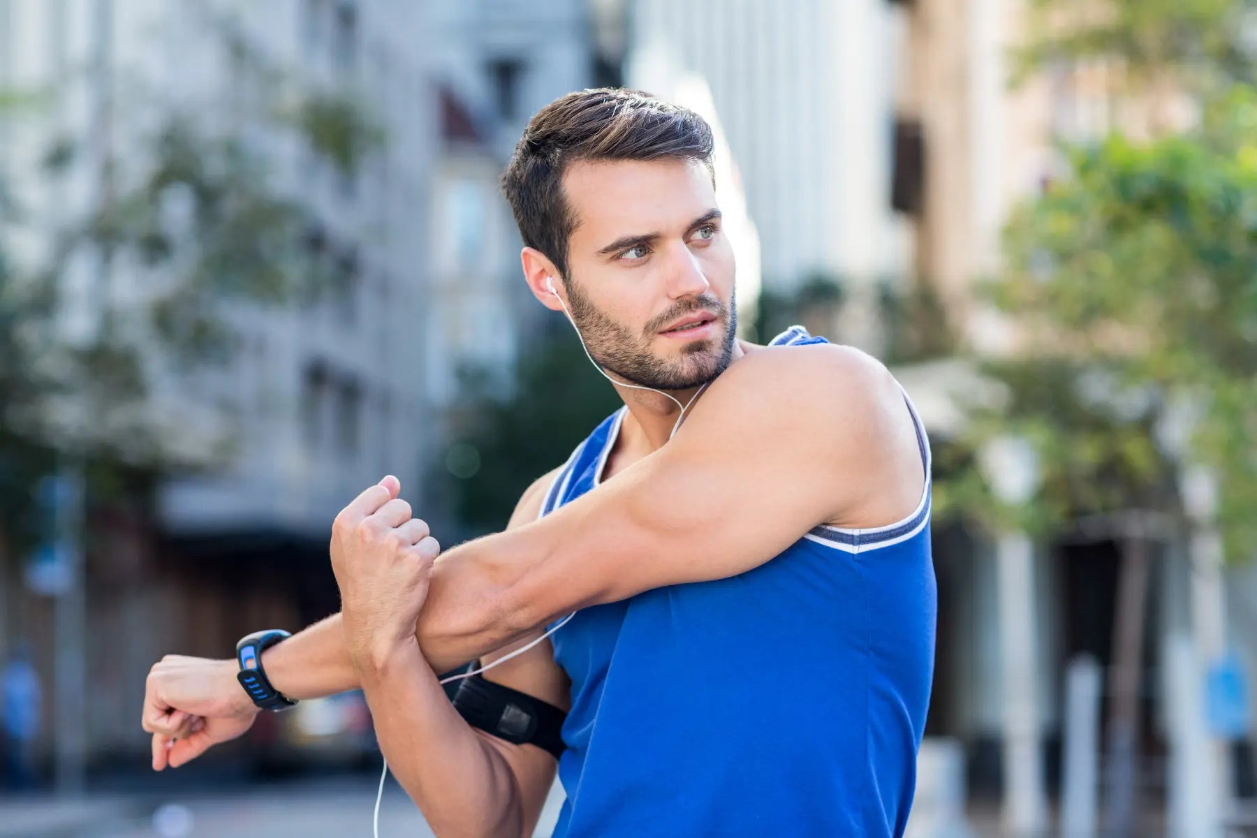 Balance gut bacteria visualized by athletic man stretching outdoors with earbuds and fitness tracker.