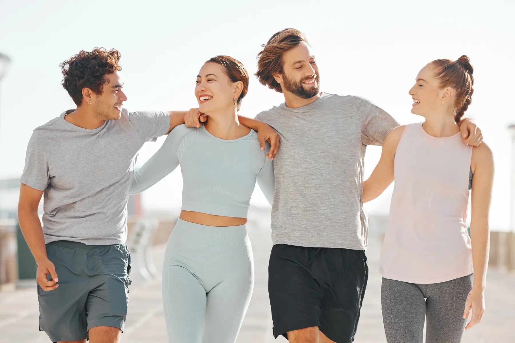 Boost metabolism naturally by staying active with friends, shown by group walking together in athletic wear.