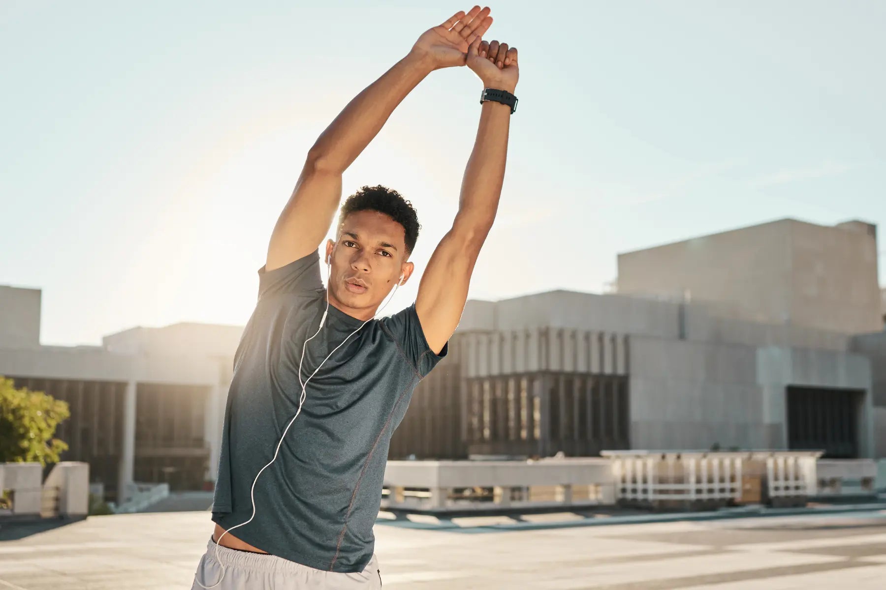 Gut health test awareness is promoted through active lifestyles, shown by a man stretching outdoors in athletic wear.