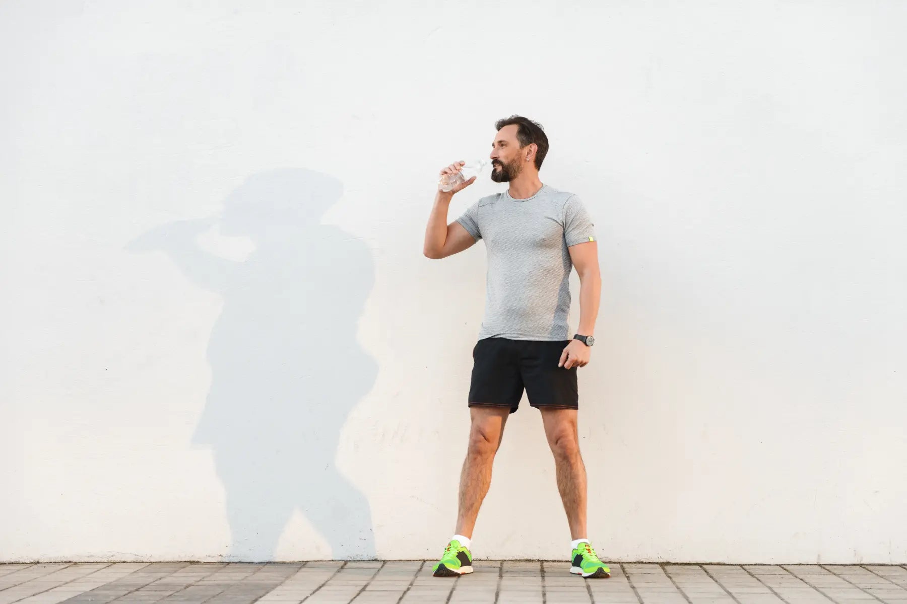 Gut microbiome testing represented by a man hydrating after exercise to support digestion, metabolism, and overall gut health