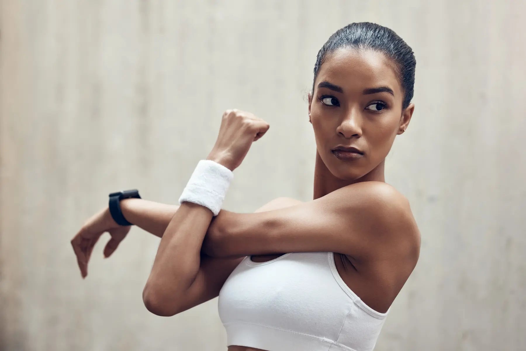 Stool antigen test for H. pylori may follow physical symptom awareness, shown by a woman stretching in athletic wear.