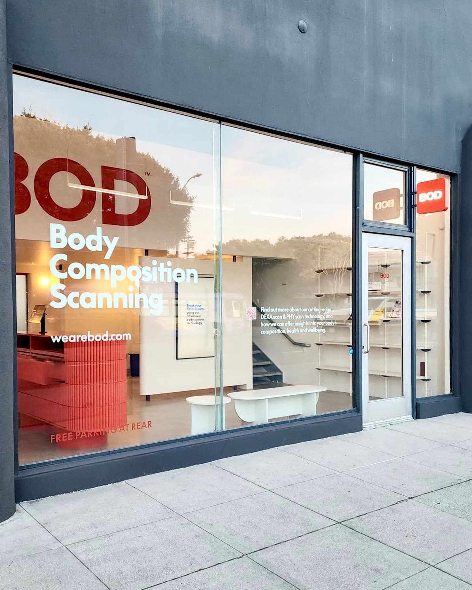 Storefront with glass door and 'BOD' branding, featuring body composition scanning services.