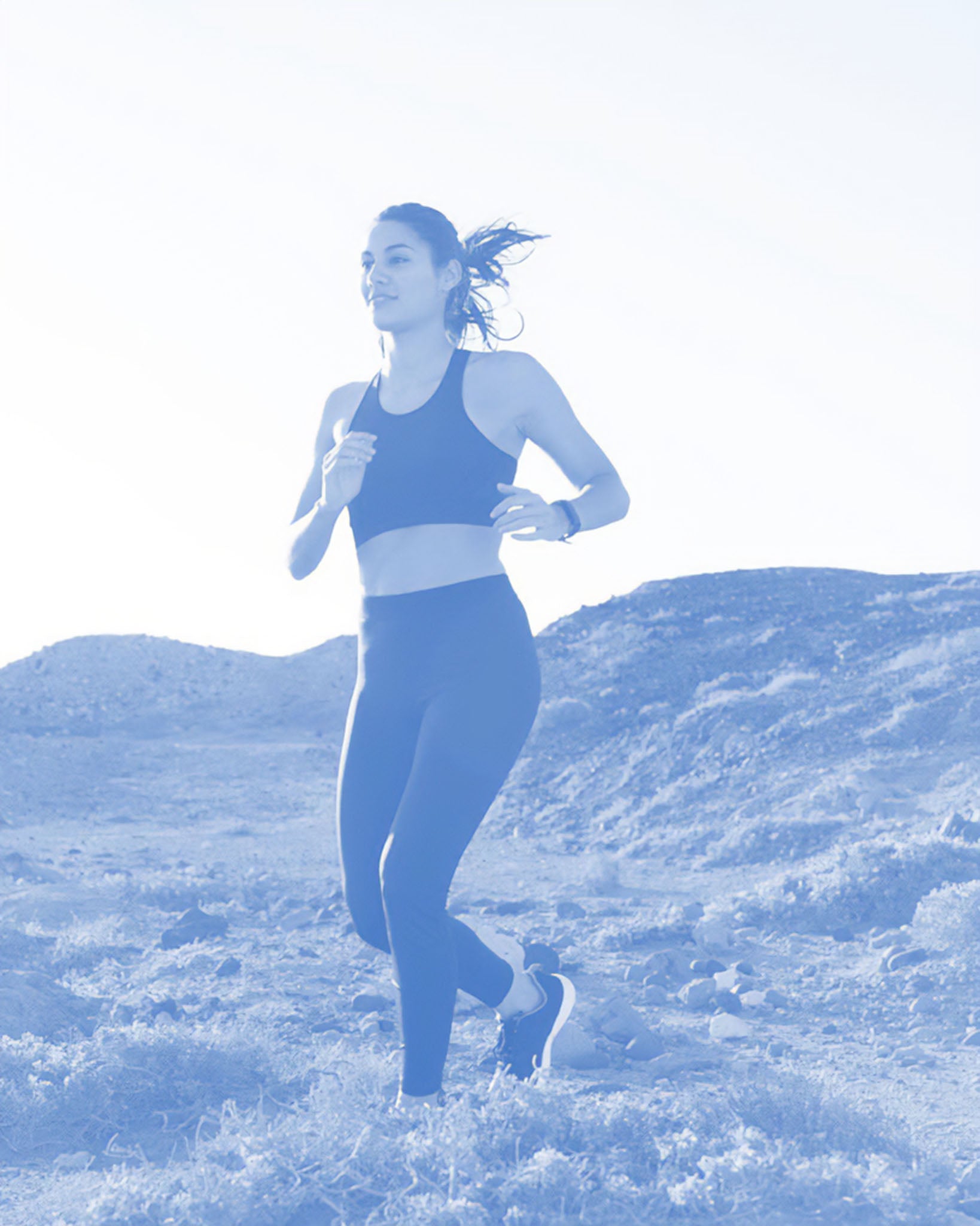 Woman running on a snowy landscape