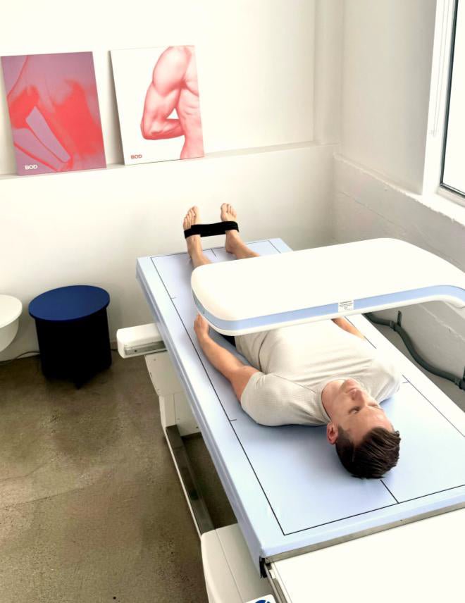 BOD customer lying on a DEXA scan table with imaging equipment above, at the BOD store in Venice, CA