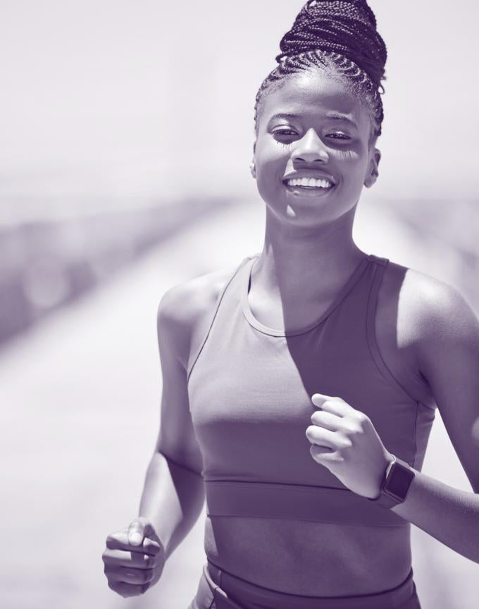 Woman running outdoors with a blurred background