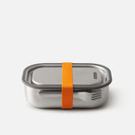 Stainless steel food container with an orange strap on a white background
